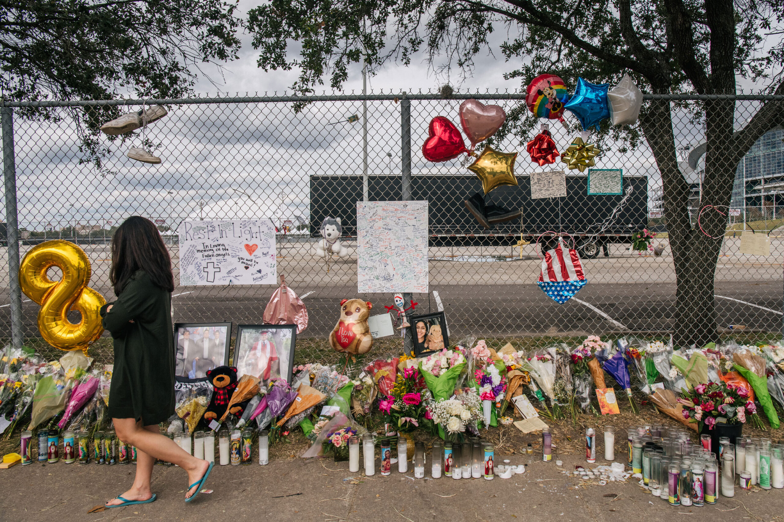 A woman walks past a memorial to those who died at the Astroworld festival outside of NRG Park on November 09