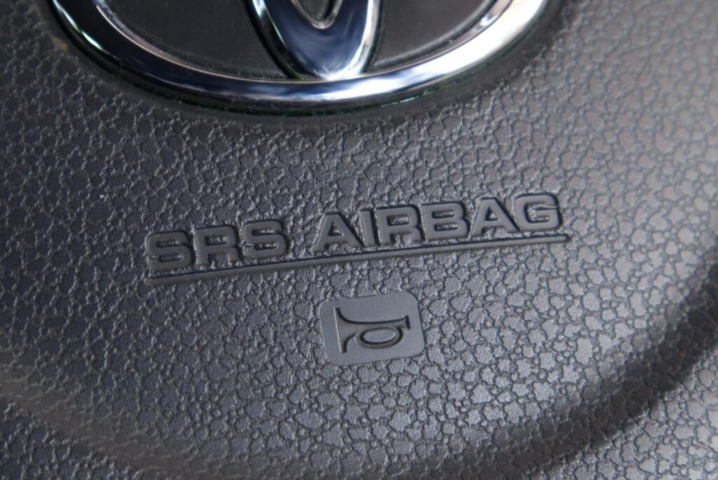 Close up of airbag text on a Toyota steering wheel, representing the Toyota air bag control unit settlement.